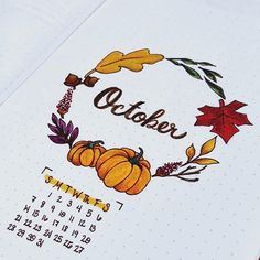 a calendar with autumn leaves and pumpkins on it