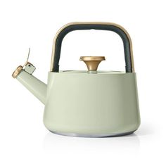 a tea kettle with a gold top and handle is shown in front of a white background