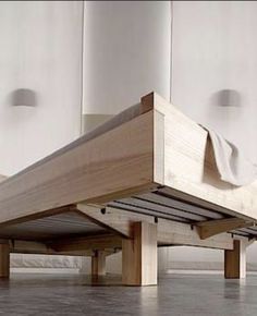 a bed that is sitting on top of a wooden platform in the middle of a room