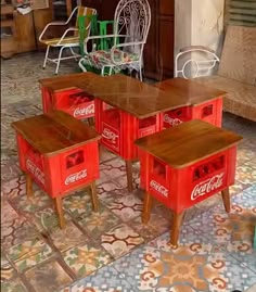 an old coca - cola machine table and stools are in the middle of a room