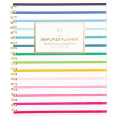 a spiral notebook with colorful stripes on the front and bottom, which reads simply planner