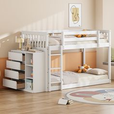 a white bunk bed sitting on top of a hard wood floor