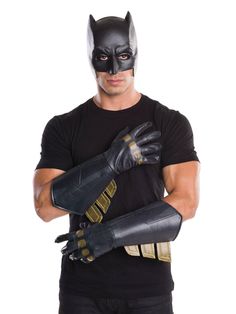 a man wearing a batman mask and gloves