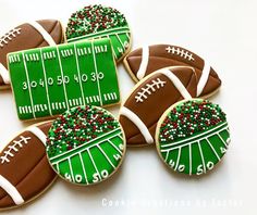 decorated football cookies are arranged on a table