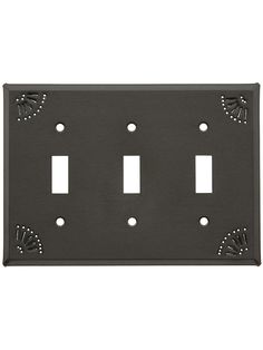 a black metal outlet cover with three flowers on the front and one light switch plate