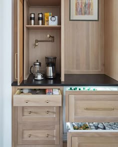 an open cabinet in a kitchen with coffee maker