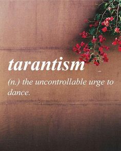 the words tarantism are written on a wall with red flowers hanging from it