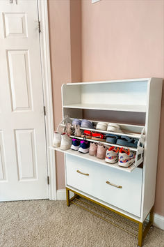 a white cabinet filled with lots of crafting supplies on top of a carpeted floor