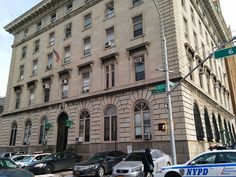 a police car is parked in front of an old building