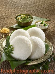 some food is sitting on a plate and ready to be eaten with sauces in the background