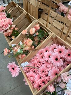 several wooden boxes filled with pink flowers