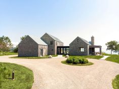 a large house sitting on top of a lush green field