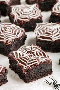 brownies with chocolate frosting and spider web decorations