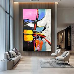 an abstract painting hangs on the wall in a modern living room with white chairs and gray couches