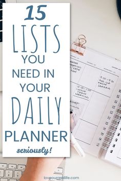 a person's hand on top of a desk next to a planner and keyboard