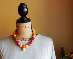 a mannequin is adorned with multicolored beads