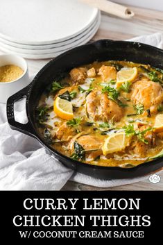 curry lemon chicken thighs with coconut cream sauce in a cast iron skillet on a wooden table