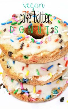 three donuts stacked on top of each other with white frosting and sprinkles