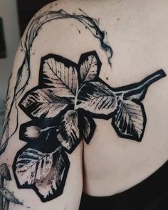 the back of a woman's shoulder with flowers on it