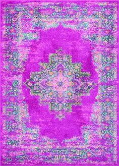 a purple rug with an ornate design in the middle and green, pink, yellow, and blue colors