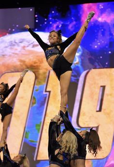 the cheerleaders are doing tricks on the stage