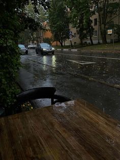 a rainy day with cars parked on the street