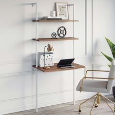 a desk with a laptop computer on top of it next to a potted plant