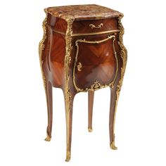 an ornately decorated wooden cabinet with gold trimmings on the top and bottom