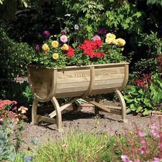 a wooden planter with flowers in it