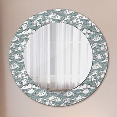 a round mirror hanging on the wall