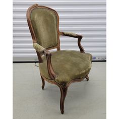 an old fashioned chair sitting in front of a garage door