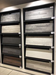 several rows of different colors and sizes of flooring samples on display in a store