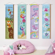 three children's growth chart wall hangings in a child's room