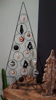 a metal christmas tree with ornaments on it