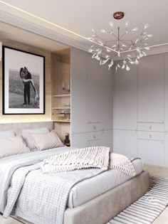 a bedroom with a large bed and a chandelier hanging from the ceiling