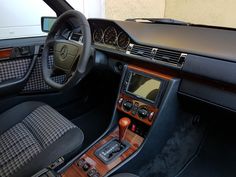 the interior of a modern car with wood trim