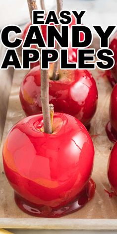 red apples sitting on top of a cutting board with the words easy candy apples above them