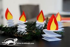 some paper candles sitting on top of a table