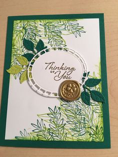 a close up of a greeting card with a stamp and a button on the front