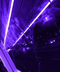 the inside of a bus with purple lights