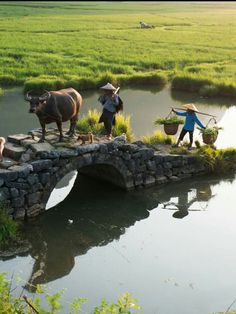 three people with animals crossing a bridge over water