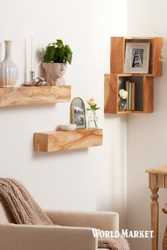 a living room filled with furniture and decor on top of wooden shelving units next to a wall