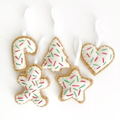 four decorated cookies in the shape of christmas trees