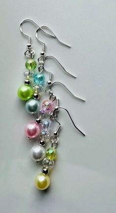 three pairs of dangling earrings with multicolored pearls and swarong crystal beads