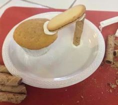 a white plate topped with cookies and marshmallows on top of a table