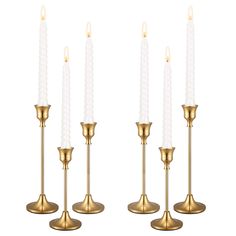 set of four brass candle holders with white candles