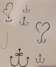 an anchor, heart, and other symbols are drawn on a white board with black ink