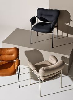 three different chairs sitting on top of each other in front of a white wall and floor