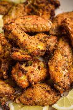 chicken wings with lemon wedges on a plate