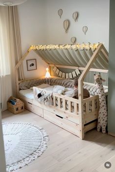 a child's bed with a tent on the top